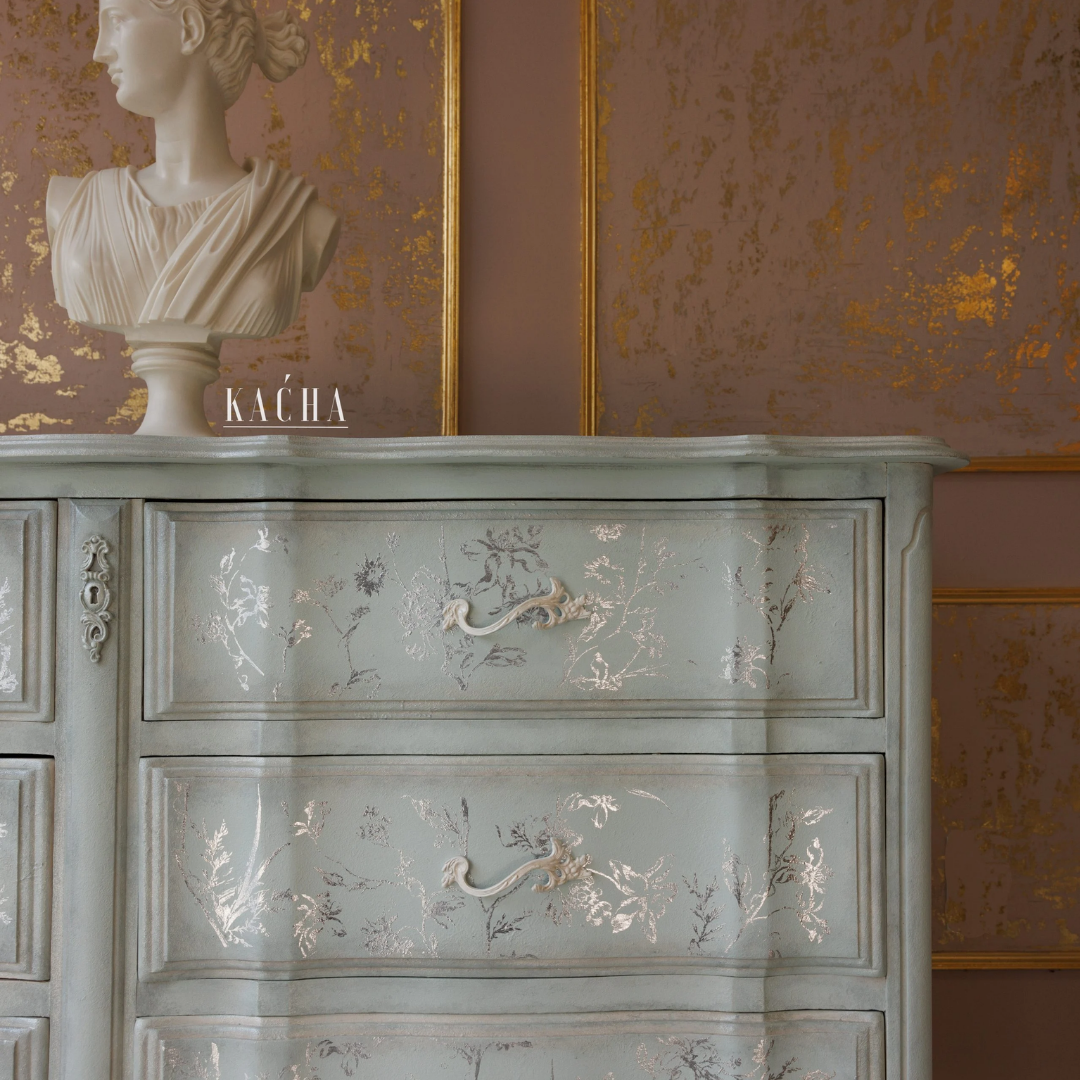Decorative cabinet with floral patterns against a wall with gold leaf design